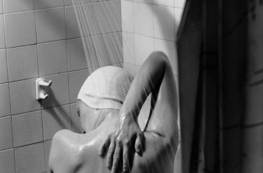 A woman takes a shower circa 1950.